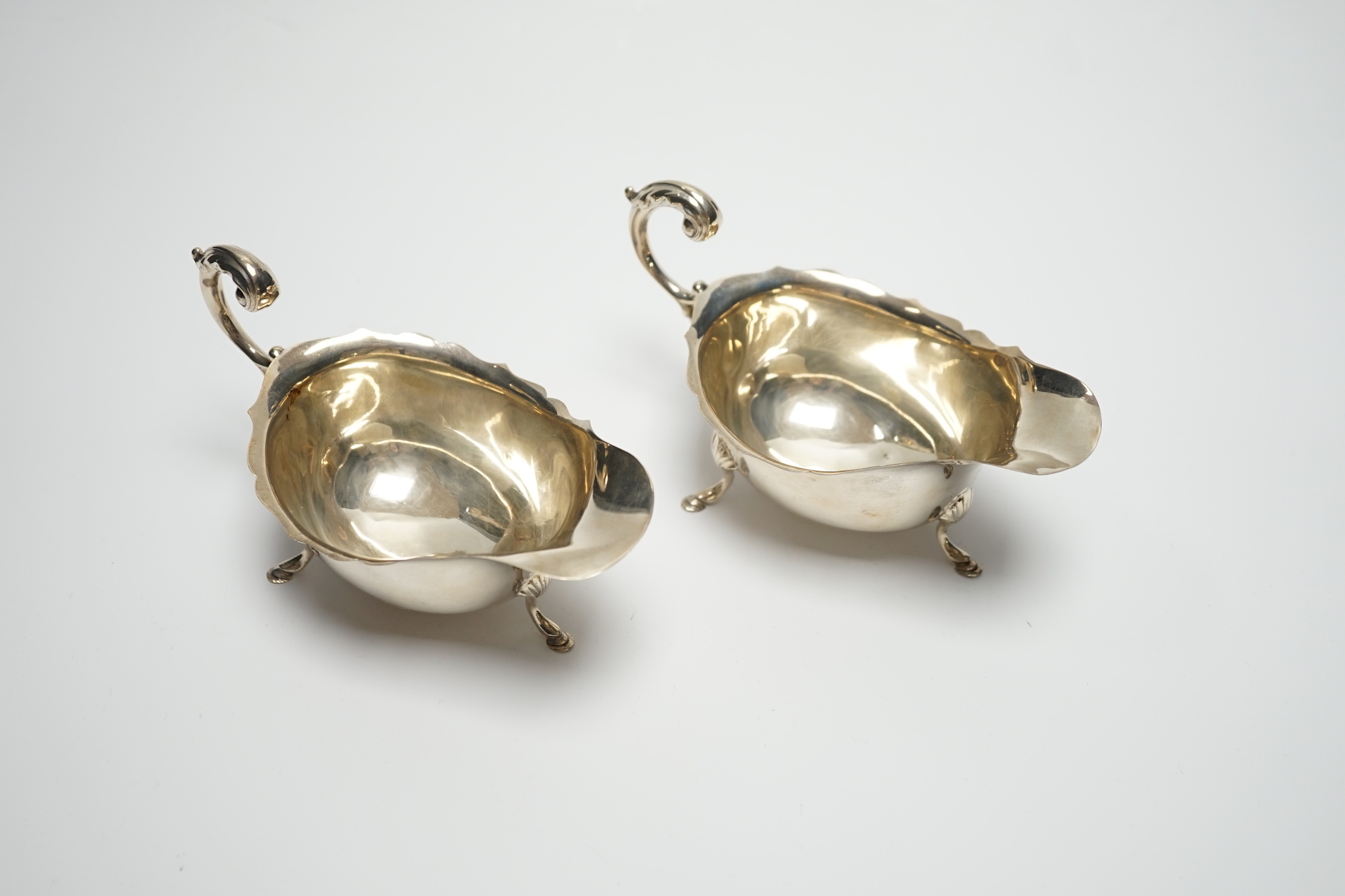A pair of George V silver sauceboats, with flying scroll handles, S. Blanckensee & Sons Ltd, Birmingham, 1927, length 15cm, 4.7oz.